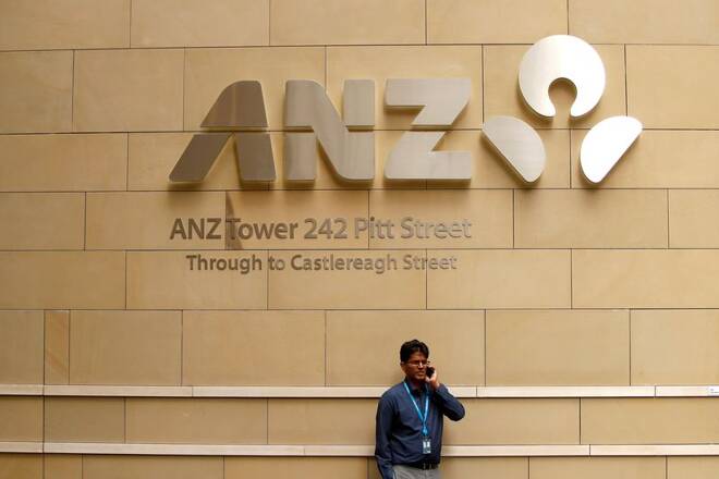 A man talks on his phone in front of an ANZ Banking corporation tower in central Sydney