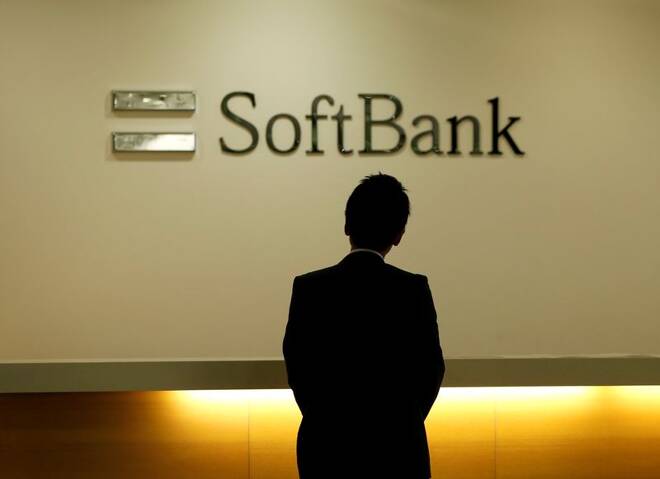 Man looks at the logo of SoftBank Group Corp at the company's headquarters in Tokyo