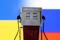 Illustration shows model of petrol pump, Ukraine and Russian flag colors
