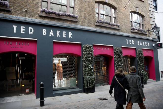 People walk past a Ted Baker store on Floral Street, in London