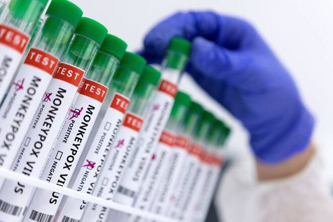 Illustration shows test tubes labelled "Monkeypox virus positive and negative