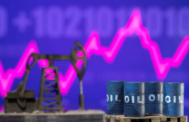 FILE PHOTO - Models of oil barrels and a pump jack are displayed in front of a rising stock graph and "$100" in this illustration