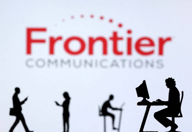 Illustration shows small toy figures with laptops and smartphones in front of displayed Frontier Communications logo