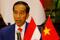 Indonesian President Joko Widodo reads his statement following a signing ceremony at the Presidential Palace in Hanoi