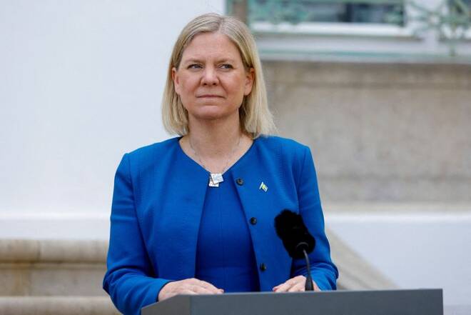 Swedish Prime Minister Magdalena Andersson looks on next to a microphone on the first day of a special German cabinet meeting hosted by Chancellor Olaf Scholz at the government's guest house Schloss Meseberg in Meseberg, Gransee, Ge
