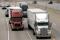 Two freight trucks are driven on the Fisher freeway in Detroit