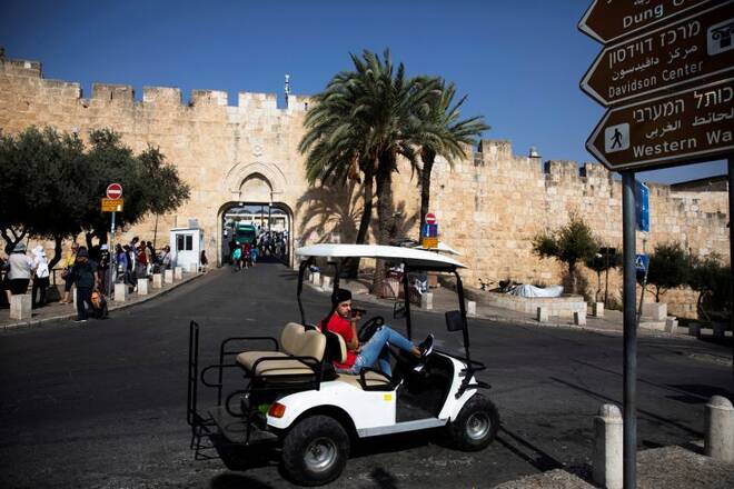 A man look on as he sits in a golf cart near Dung Gate, close to the Western Wall in Jerusalem's Old City