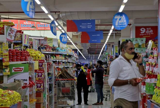 Customers buy grocery items inside a superstore of Reliance Industries Ltd, in Mumbai