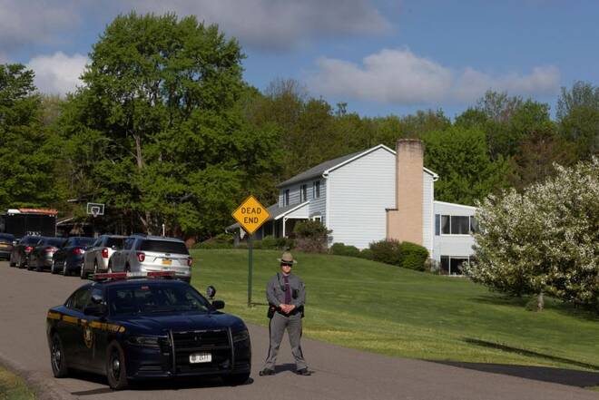 Law enforcement personnel stands outside the home of Buffalo supermarket shooting suspect in Conklin, New York