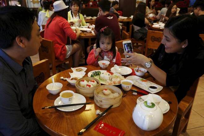 A family takes pictures as they dine in a Hello Kitty-themed Chinese restaurant in Hong Kong