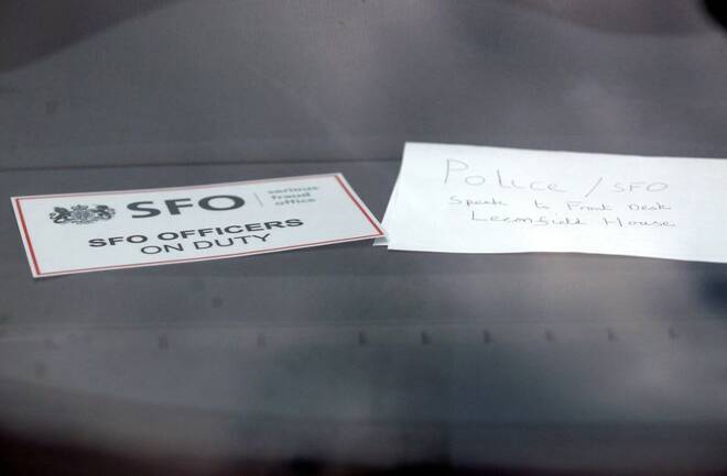 A sign is displayed in an unmarked Serious Fraud Office vehicle parked outside a building, in Mayfair, central London