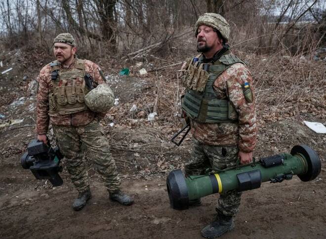 Ukrainian service members hold a Javelin missile system at a position on the front line in the north Kyiv region