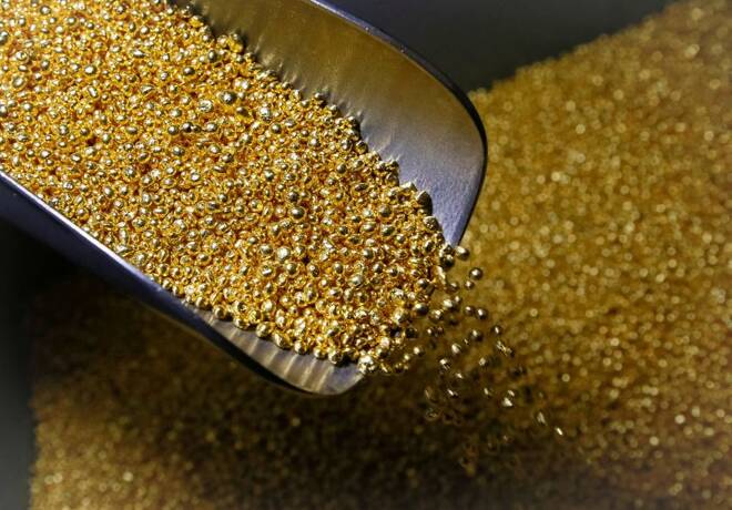 An employee takes granules of 99.99 percent pure gold at the Krastsvetmet non-ferrous metals plant in the Siberian city of Krasnoyarsk