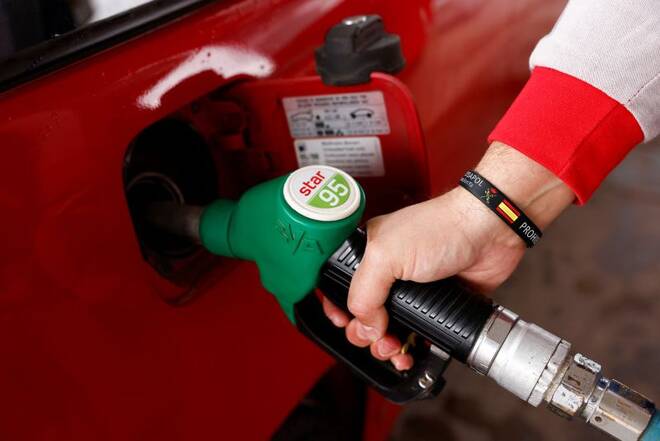 A worker pumps petrol into a customer's car at a Cepsa petrol station in Cuevas del Becerro, near Malaga