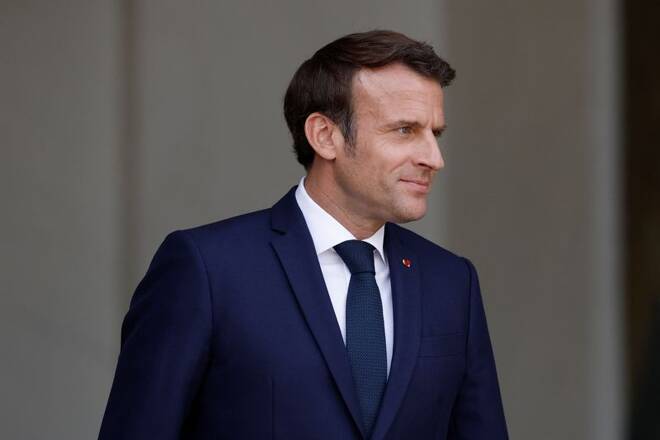French President Emmanuel Macron welcomes a guest at the Elysee Palace in Paris