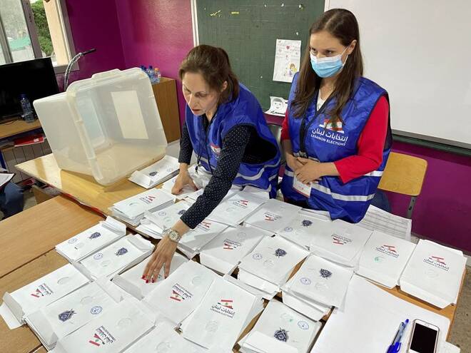 Electoral workers sort ballots after polls closed during Lebanon's parliamentary election, in Khiam