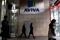 People enter and exit the AVIVA headquarters building in Dublin.
