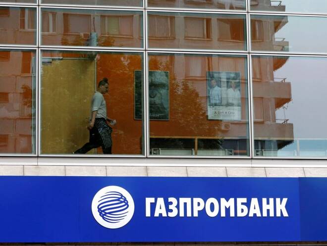 A person is pictured through a window above a Gazprombank branch in Moscow