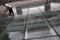 A worker cleans a glass floor reflecting Sinosteel's logo, in front of itsheadquarters building in Beijing