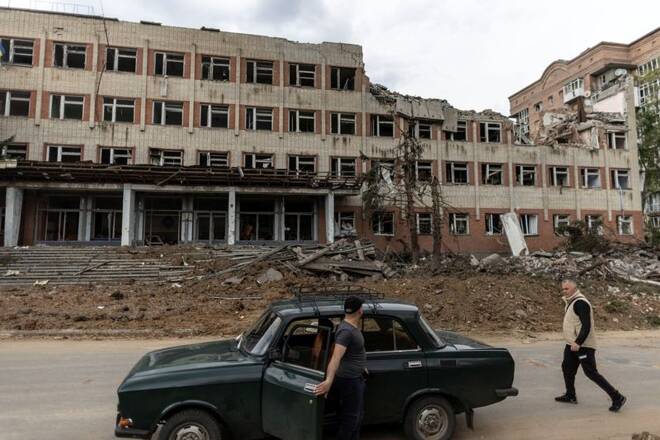 Local resident walks by a destroyed building after a rocket attack on a university campus, amid Russia's invasion, in Bakhmut