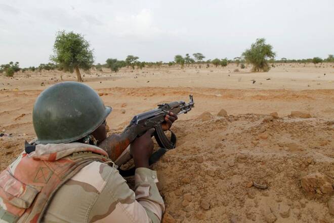 A Niger soldier guards with his weapon pointed towards the border with neighbouring Nigeria, near the town of Diffa
