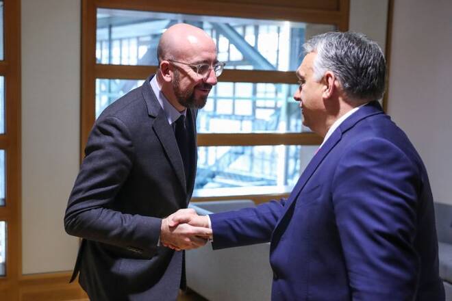 European Council President Charles Michel shakes hands with Hungarian Prime Minister Viktor Orban before their meeting at the European Council headquarters in Brussels
