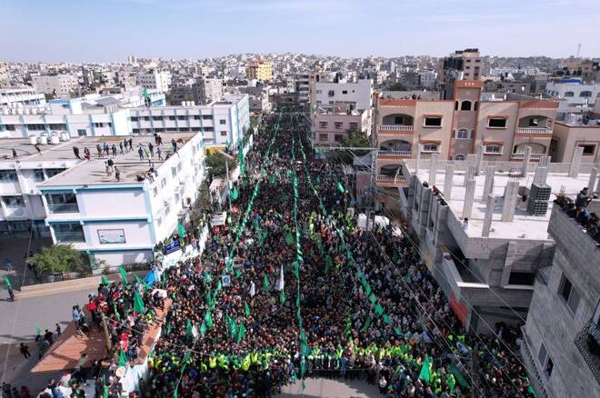 Palestinians take part in a rally marking the 34th anniversary of Hamas' founding, in the northern Gaza Strip