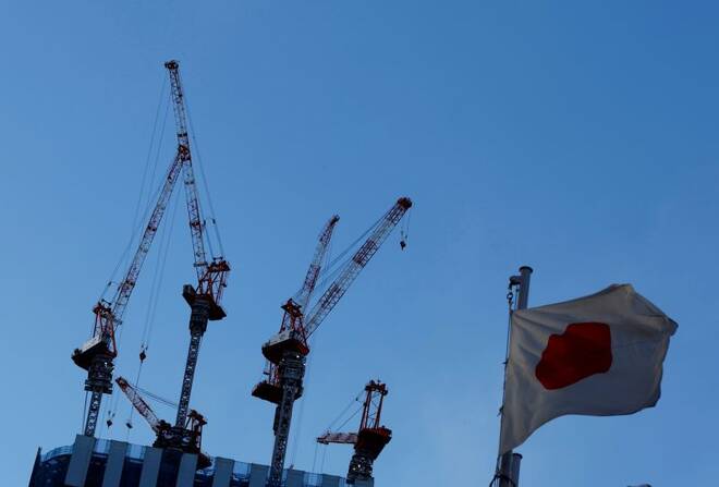 Japan's national flag flutters in front of a construction site of a commercial building in Tokyo