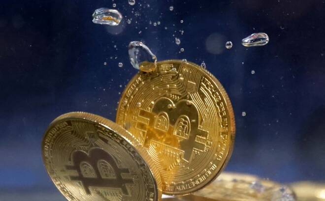 Illustration shows representation of cryptocurrency Bitcoin plunging into water
