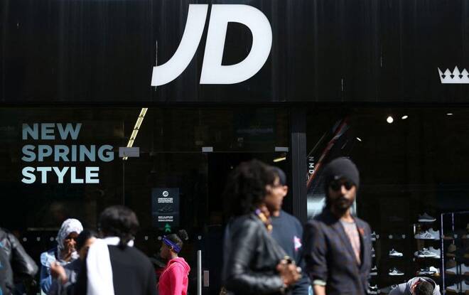 People pass a JD Sports store in London