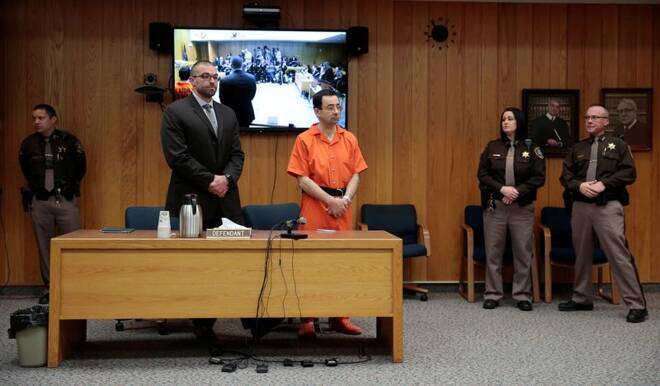 Larry Nassar, a former team USA Gymnastics doctor who pleaded guilty in November 2017 to sexual assault charges, and his defense attorney Matt Newburg stand during Nassar's sentencing hearing in the Eaton County Court in Charlotte