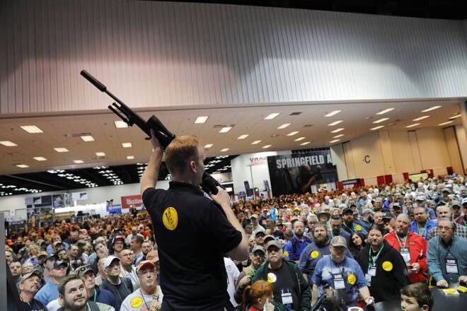 A man auctions off a Daniel Defense rifle during the National Rifle Association (NRA) annual meeting in Indianapolis, Indiana