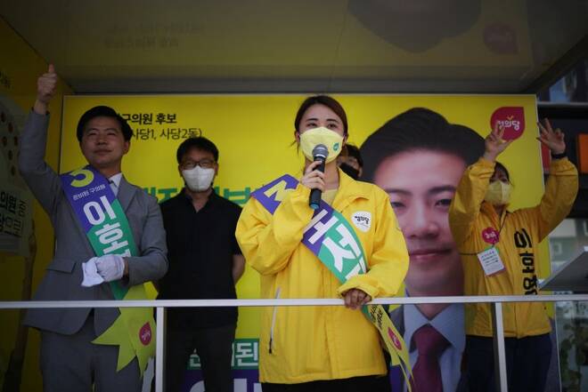 College student and a proportional representation candidate of the Justice Party for the Seoul City Council, partakes in an election campaign rally in Seoul