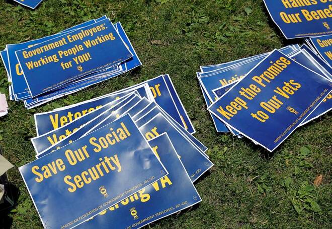 Signs are pictured on the ground during a noon-time rally of federal employees on Independence Mall to protest proposed cuts in federal funding in Philadelphia