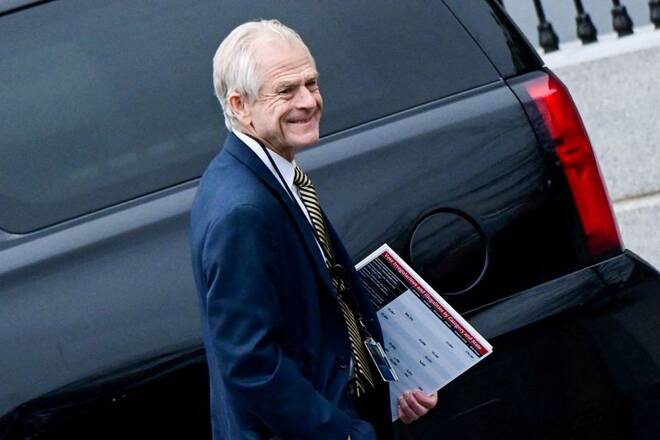 Former White House advisor Peter Navarro leaves the West Wing carrying a poster board displaying claims of voting irregularity at the White House in Washington