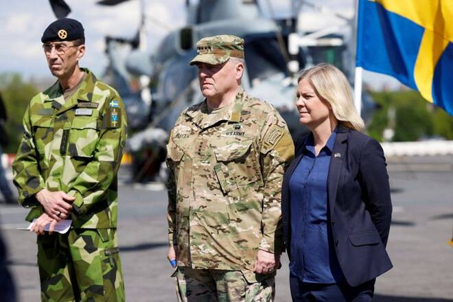 Supreme Commander of the Swedish Armed Forces, General Micael Byden, U.S. chairman of the Joint Chiefs of Staff Milley and Swedish PM Andersson stand aboard the USS Kearsarge, in Stockholm