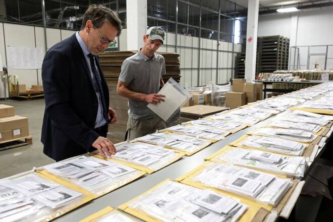 Canada's Chief Electoral Officer Stephane Perrault looks at materials at the Elections Canada distribution centre in Ottawa