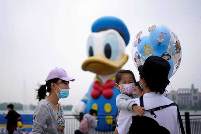 Visitors wearing face masks are seen at Shanghai Disney Resort