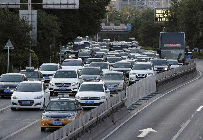 Cars drive on the road during the evening rush hour in Beijing