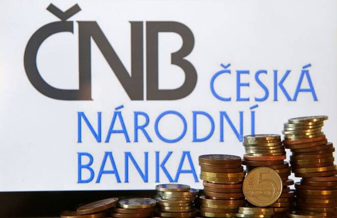 Czech Crown coins are seen in front of a displayed logo of Czech central bank (CNB) in this picture illustration