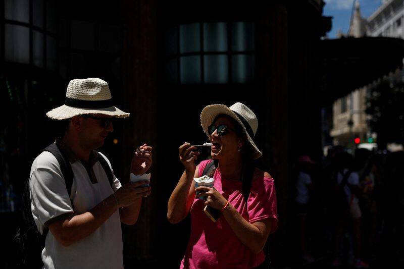 People eat ice cream on a hot day as Spain braces for a heatwave in Madrid