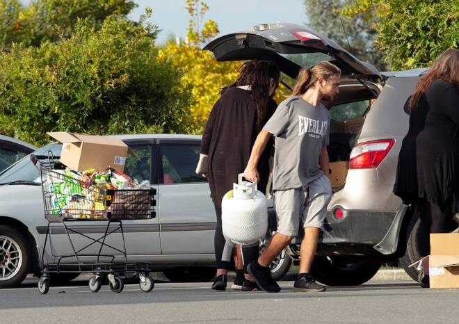 People take out products from their supermarket shopping cart and load them into their car outside Pak'nSave supermarket amid the spread of the coronavirus disease (COVID-19) in Christchurch
