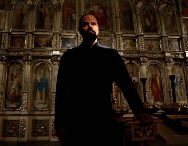 Parish priest Andriy Klyushev poses for a photo, as Russia's attack on Ukraine continues, in Saint Nicholas church, Irpin