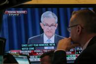A trader watches, U.S. Federal Reserve Chairman Jerome Powell on a screen on the floor at the NYSE in New York