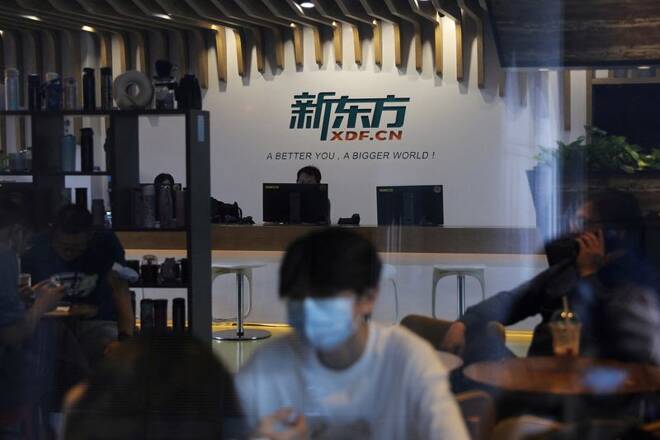 People sit at a cafe inside the headquarters of New Oriental Education & Technology in Beijing