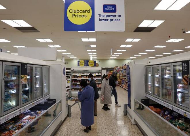 Shoppers are seen inside a branch of a Tesco supermarket in London