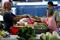 A customer pays for vegetables at a wet market in Klang