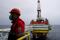 An employee is seen at an oil platform operated by Lukoil company at the Kravtsovskoye oilfield in the Baltic Sea