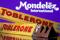 Toblerone Swiss milk chocolates are seen displayed in front of Mondelez International logo in this illustration picture