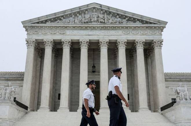 Police officers walk outside the U.S. Supreme Court in Washington